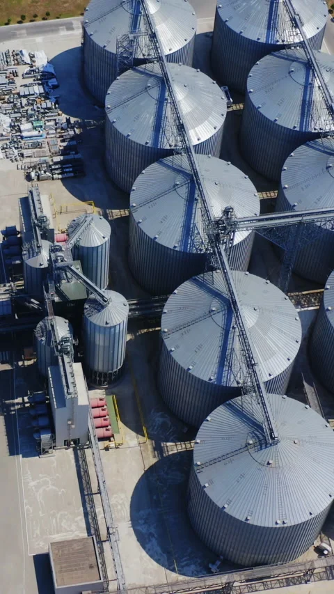 Metal elevators on field. Granary for storing cereals. Stock Footage 272686032