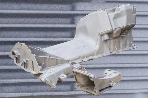 Metal engine component displayed against a textured gray background highlig.. 스톡 사진