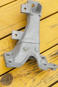 Metal engine component displayed against a textured gray background highlig.. Foto stock