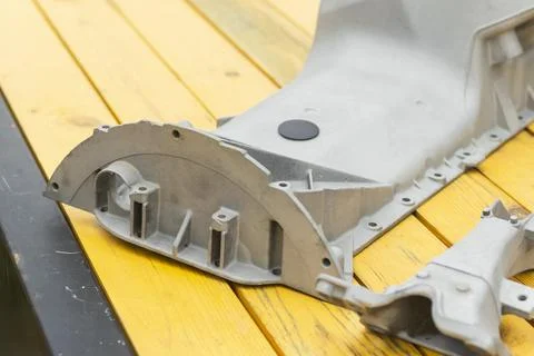Metal engine component displayed against a textured gray background highlig.. Foto stock