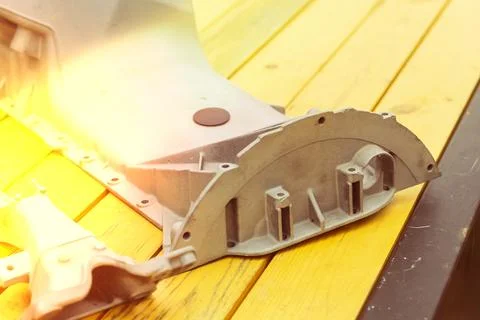 Metal engine component displayed against a textured gray background highlig.. Foto stock