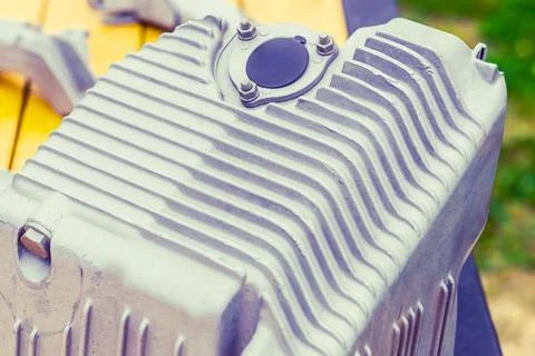 The metal engine component showcases intricate design features, capturing the Stock Photos