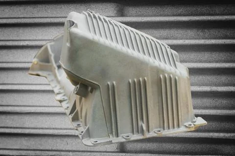 The metal engine component showcases intricate design features, capturing the Foto stock