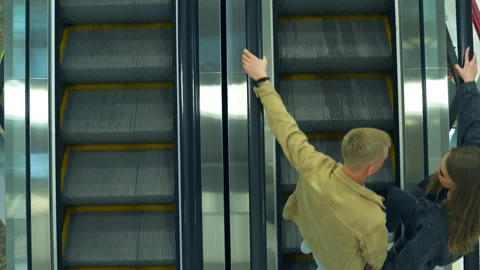 Metal escalator stairs moving in both directions up and down.  Stock-Footage 173802153