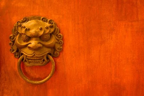 Metal evil face pull door and hard wood surface background Stock Photos