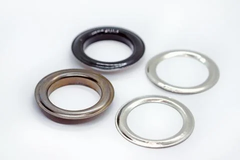 Metal eyelets with reverse ring, dark nickel and black lacquered. Accessories Stock Photos