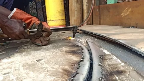 Metal Fabrication Worker Using Plasma Cutter for Precise Metal Cutting Stock Footage 301233247
