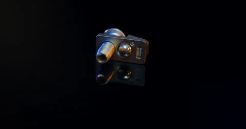 Metal fastening component with blue elements rotating on black background Vídeo Stock 331453927