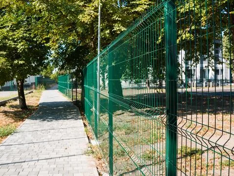 Metal fence made of mesh with rectangular cells 스톡 사진