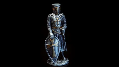 A metal figure of a medieval knight dressed in heavy shiny armor rotates Stock Footage 120731258