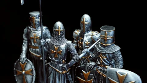 A metal figures of a medieval knights dressed in heavy shiny armor rotates  Stock Footage 120731400