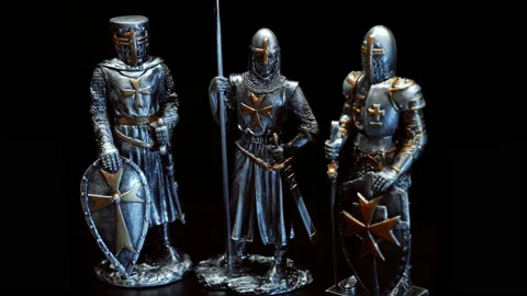 A metal figures of a medieval knights dressed in heavy shiny armor rotates  Stock Footage 121588357