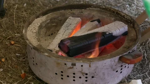 Metal fire pit sits on dry grass Stock Footage 328617044