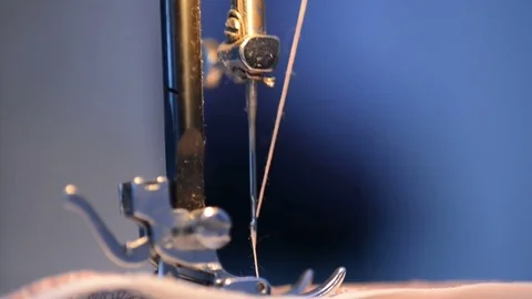 The metal foot from the sewing machine scribbles quickly to the fabric Stock Footage 74155787