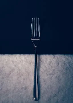 Metal fork on a black background Stock Photos