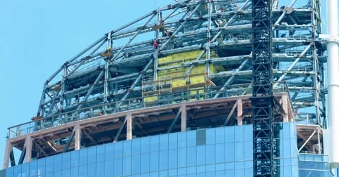 Metal frame at construction industry development site with cranes 4K, from RAW Stock Footage 66692963