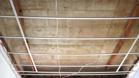 Metal frame grid installed under concrete ceiling slab for drywall Stock Footage 340543359