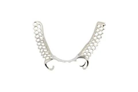 Metal frame work with clasps for partial denture on a white background Stock Photos