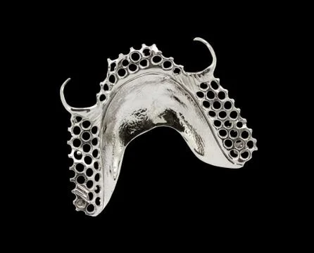 Metal frame work with clasps for partial denture on a white background 库存照片