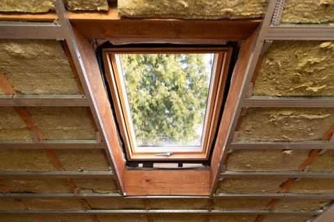 Metal frames on attic skylight window and environmentally friendly and energy Stock Photos