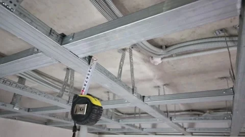 Metal framework for hung ceiling and tape rule in new flat Stock Footage 45230583