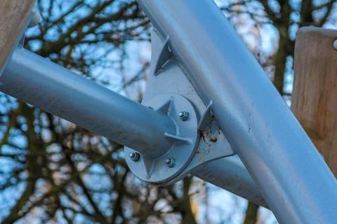Metal framework of a playground structure under a clear blue sky Stock Photos