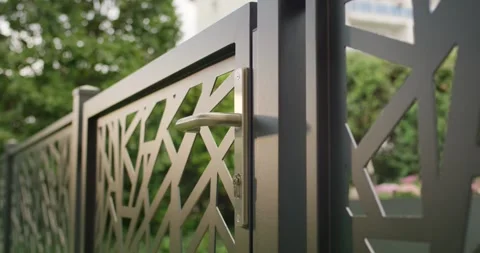 Metal Gate With Geometric Pattern Showing Handle and Lock Detail Stock Footage 340295416