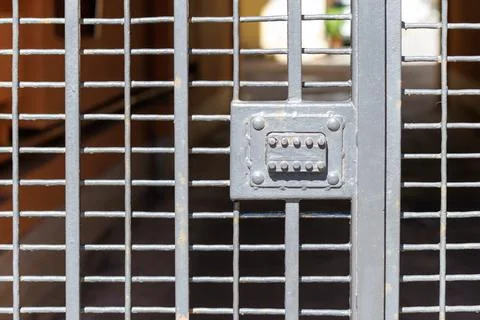 Metal gate with grid pattern and central locking mechanism Stock Photos