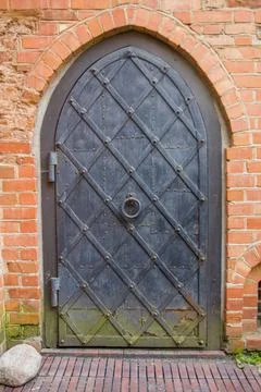 Metal gate with rust and mold in brick wall Stock Photos