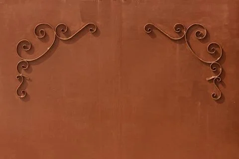 Metal gates with a pattern in the form of curls covered paint. metal brown... Stock Photos