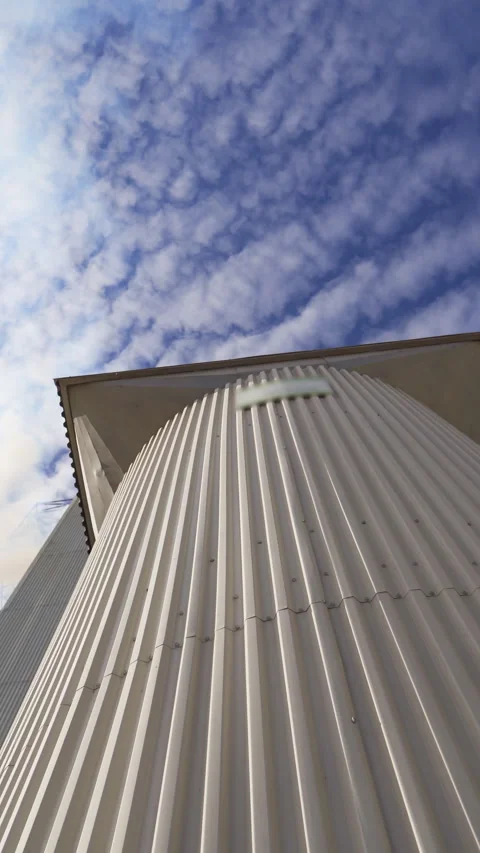 Metal grain elevator on sky background.  Stock Footage 292011664