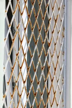 Metal grate with rusted diamond pattern Stock Photos