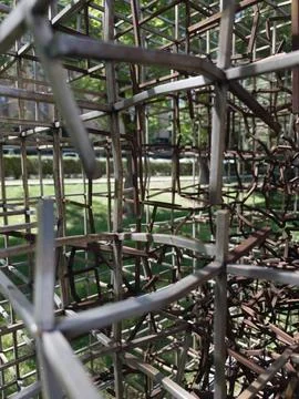 Metal grid structure forms intricate, tangled patterns Stock Photos