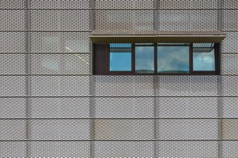 Metal grid with window on facade Stock Photos