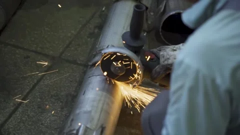 Metal grinding with sparks worker using angle grinder, macro shot Stock Footage 314057396
