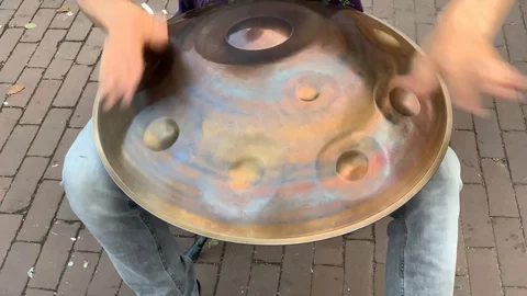 Metal Hand Drum being played in the street Stock Footage 128589090