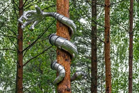 Metal hand on a pine. Stock Photos