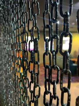 Metal hanging chains in the interior. chain curtain. modern high-tech interio Stock Photos