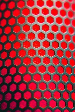 Metal hexagon grid over a red microphone Stock Photos