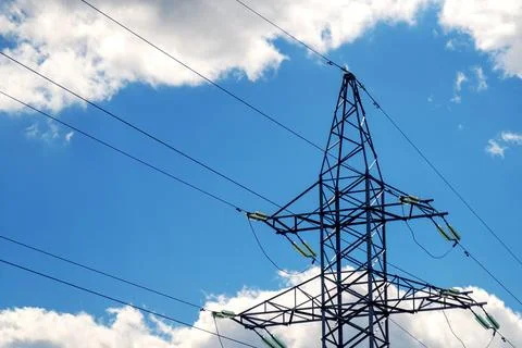 Metal high-voltage support structure with wires against a cloudy sky, symbo.. Stock Photos