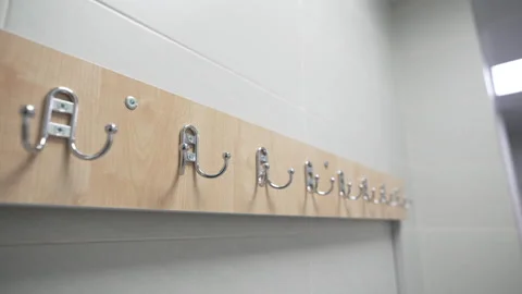 Metal hooks installed on wood panel brighten changing room Видео 311385992