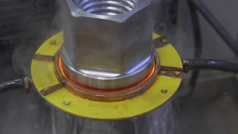 Metal induction hardening machine. Process of quenching metal with a high Stock Footage 128981420