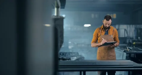 Metal industry worker with a digital tablet at the plant 動画素材 147284366
