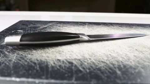 Metal Kitchen Knife On Scratched Table Panning Movement Closeup Stock-Footage 77527886