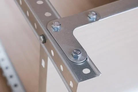 Metal L-shaped corner bracket for fixing parts of a prefabricated structure Stock Photos