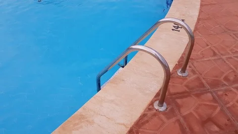 Metal ladder to the pool. in the pool is clear blue water. Stock Footage 124541841