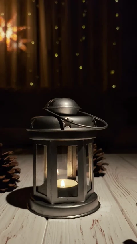 Metal lantern with candlelight and pinecones in a festive setting Stock Footage 305832407
