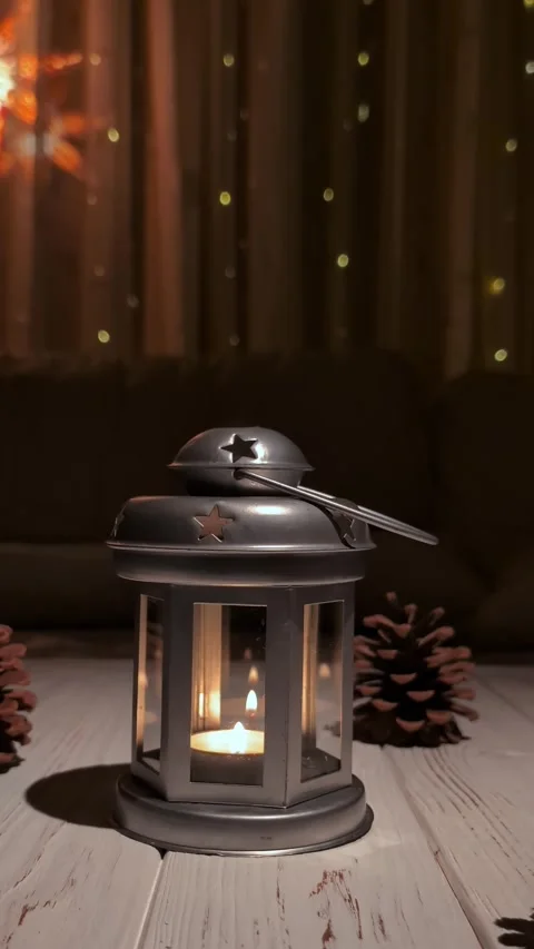 Metal lantern with candlelight as the camera pulls away in a dolly shot Video stock 305459233