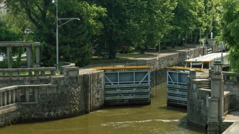 Metal lock gates open at the historic Smichov Lock Chamber in Prague city. Stockbeeldmateriaal 341972398