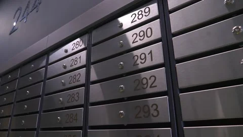 Metal mailboxes with apartment numbers in a multi-story building Stock Footage 321004398
